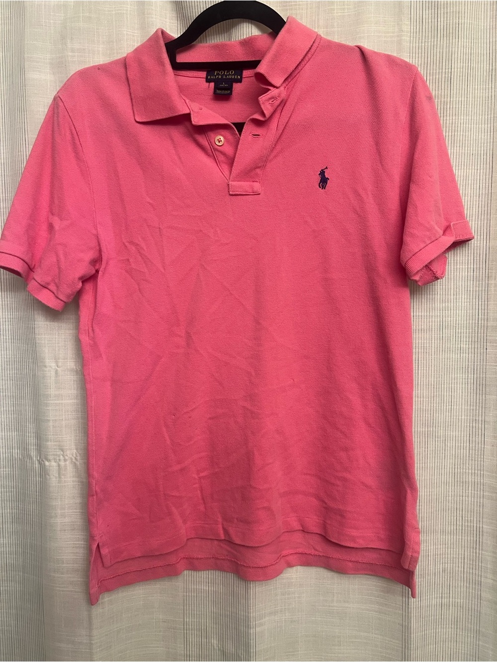 Pink Ralph Lauren polo shirt, great for elevating your look in a preppy way!